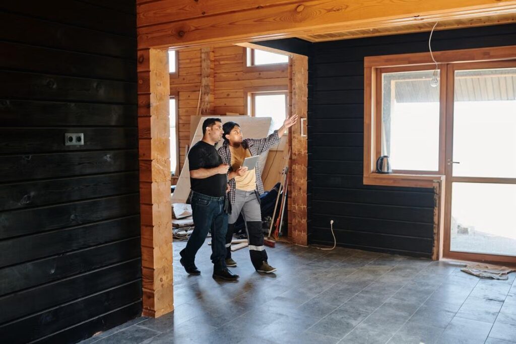 An image of contractors discussing a remodeling project